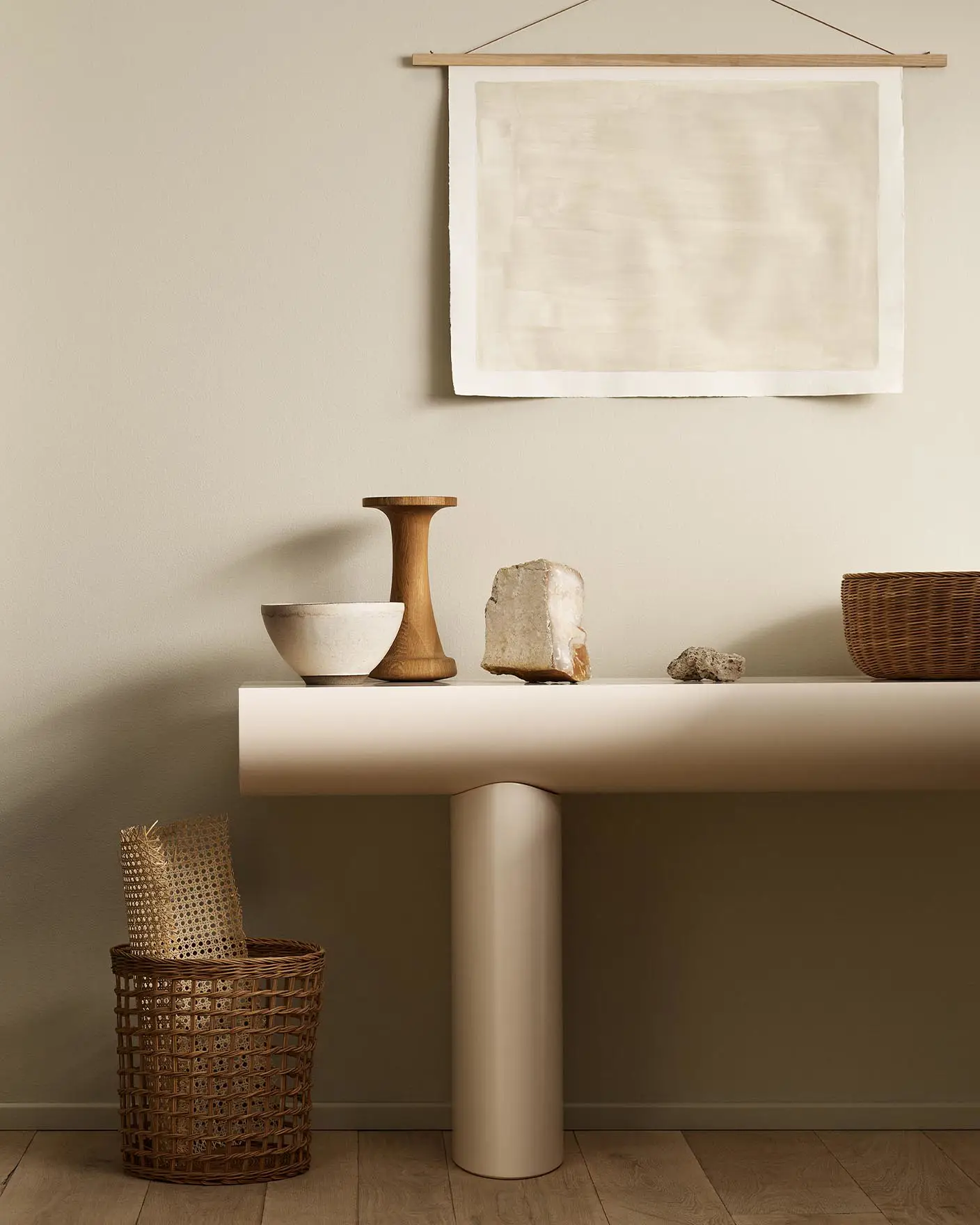 Minimalist console table with decor and baskets against a golden beige wall painted with Jotun's colour 12308 Unbleached.