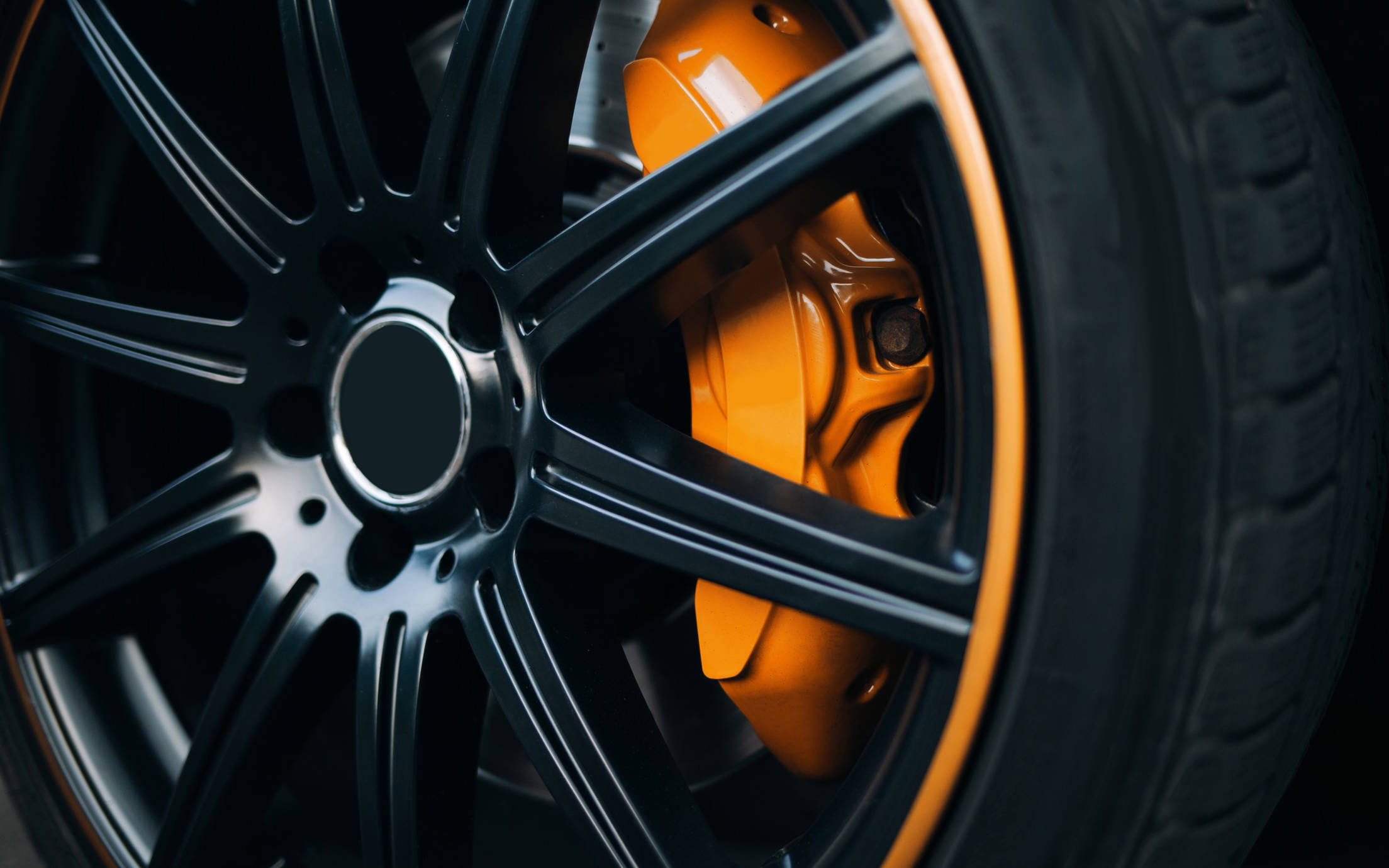 Automotive yellow and black coated wheel close up