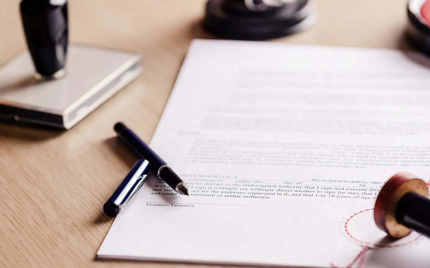 Photo of signed documents and pen laying next to it