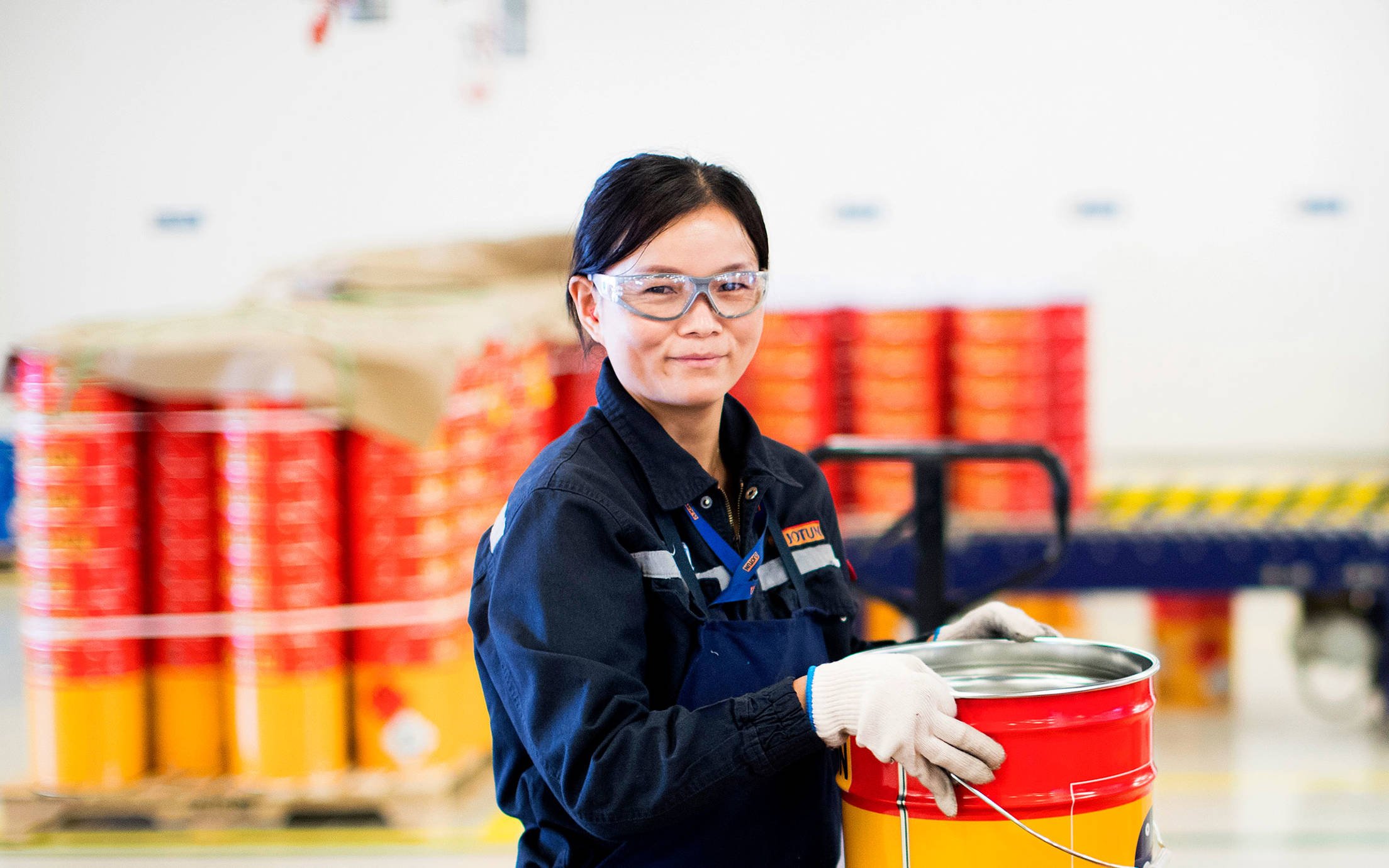 Female factory worker with a Jotun can